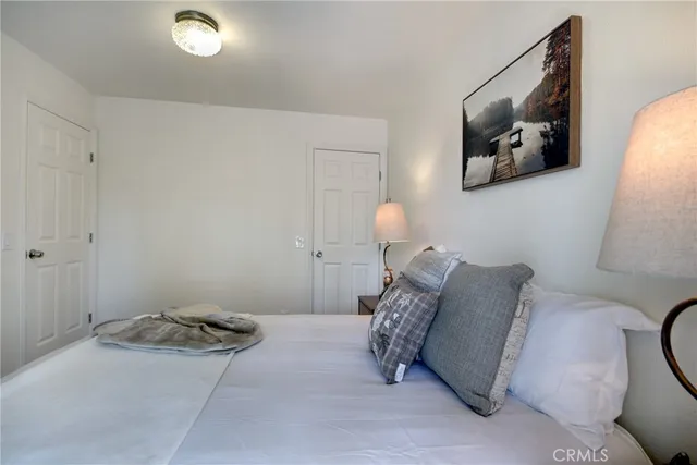 a bed room with a bed and a painting on the wall