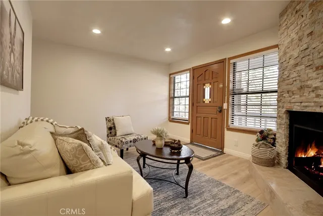 a living room with furniture and a fireplace