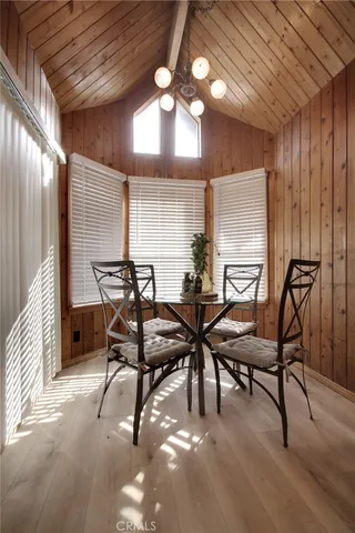 a view of a room with chairs and wooden floor