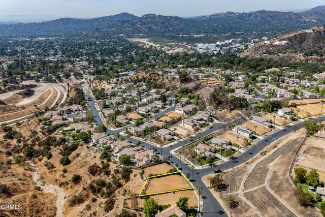 an aerial view of residential house and sandy dunes