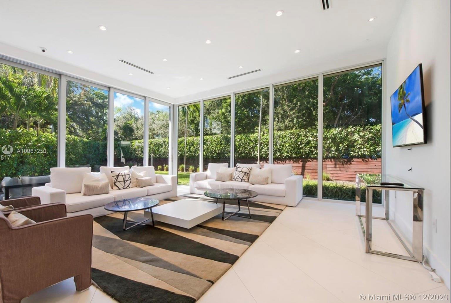 4080 Ensenada Avenue Miami, FL 33133 - Photo 1 of 16 a living room with furniture and a large window