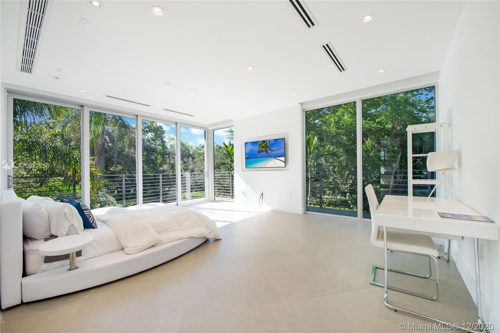 4080 Ensenada Avenue Miami, FL 33133 - Photo 9 of 16 a bedroom with furniture and large windows