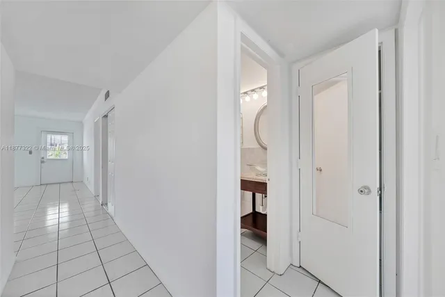 a view of a room that has a bed and a window