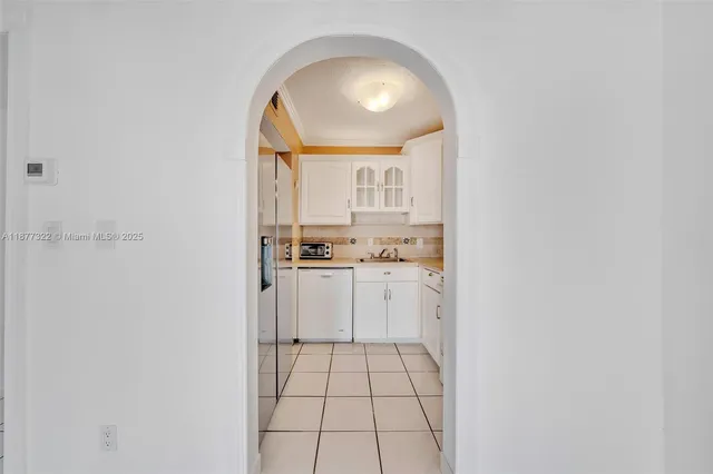 a kitchen with a white cabinets and white appliances
