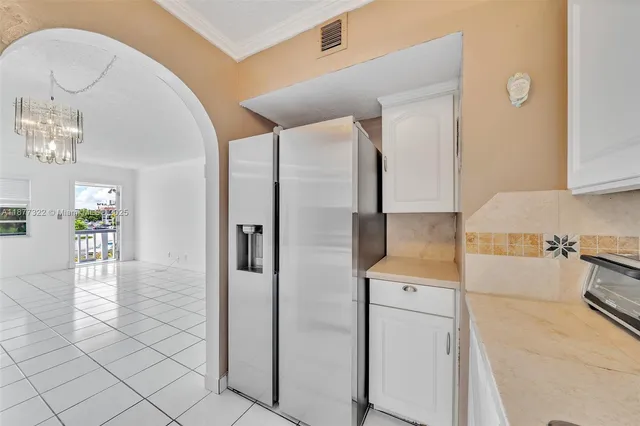 a kitchen with a refrigerator and cabinets