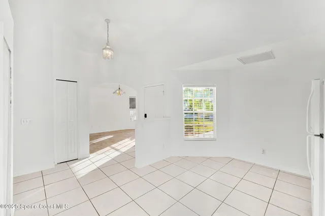 a view of a kitchen with white cabinets