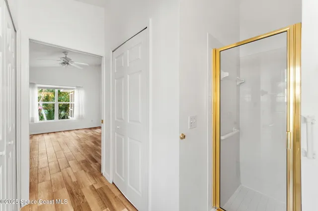 a bedroom with a bed and painting on the wall