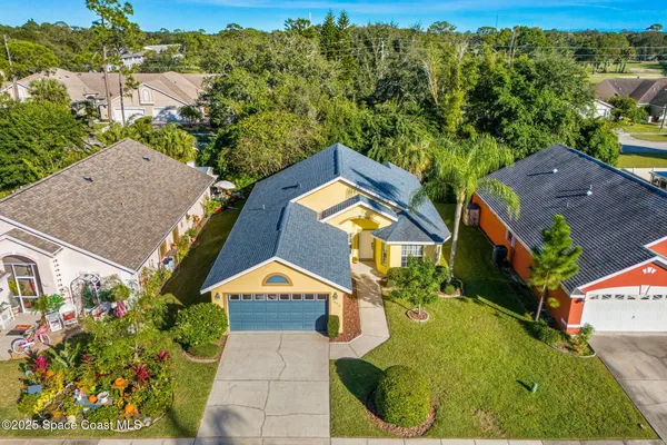 an aerial view of a house with swimming pool and outdoor space