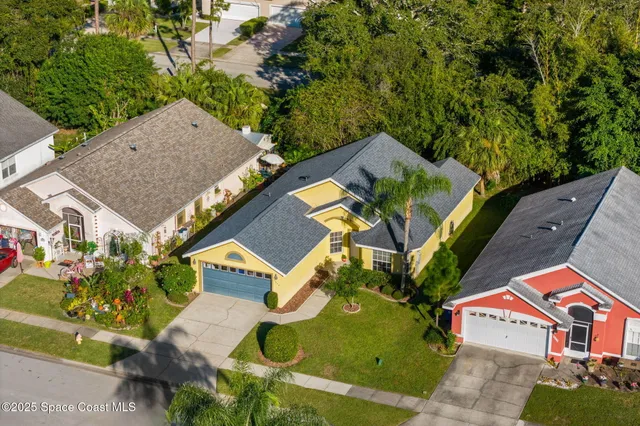 an aerial view of a house with a swimming pool yard and outdoor seating