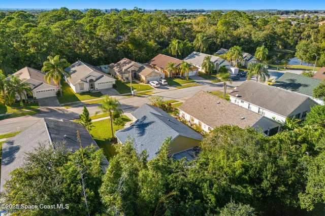 an aerial view of a house with a yard