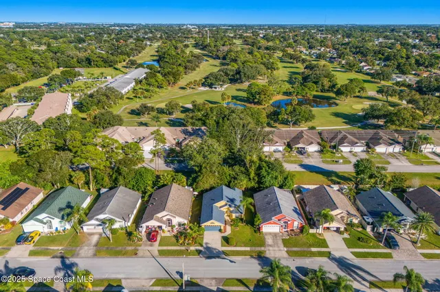 an aerial view of residential houses with outdoor space