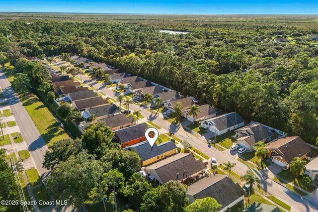 an aerial view of residential houses with outdoor space
