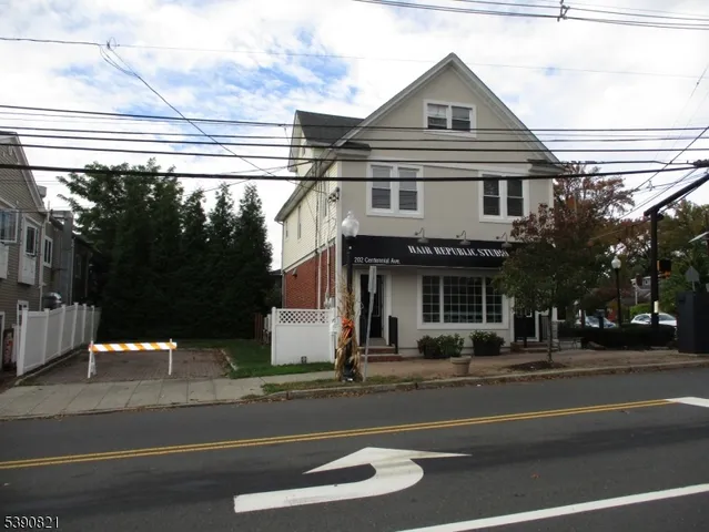 a view of a white house with a street