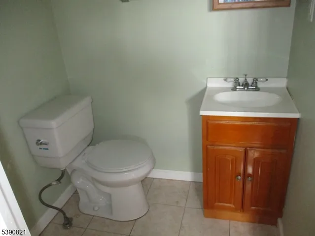 a white toilet sitting next to a bathroom sink