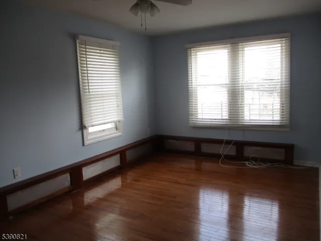 a room with wooden floor and a window