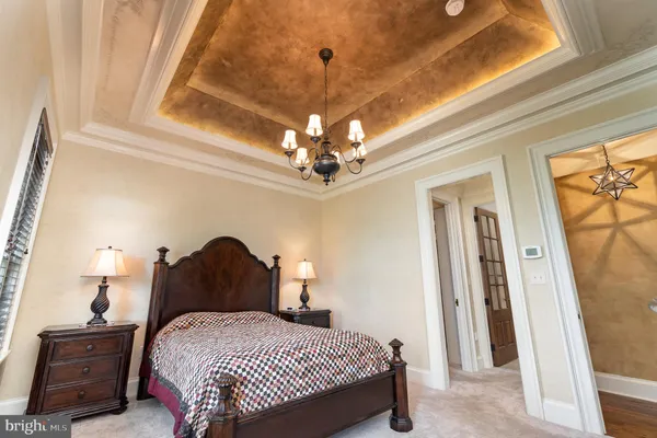 a dining hall with stainless steel appliances kitchen island granite countertop a table chairs and a wooden cabinets