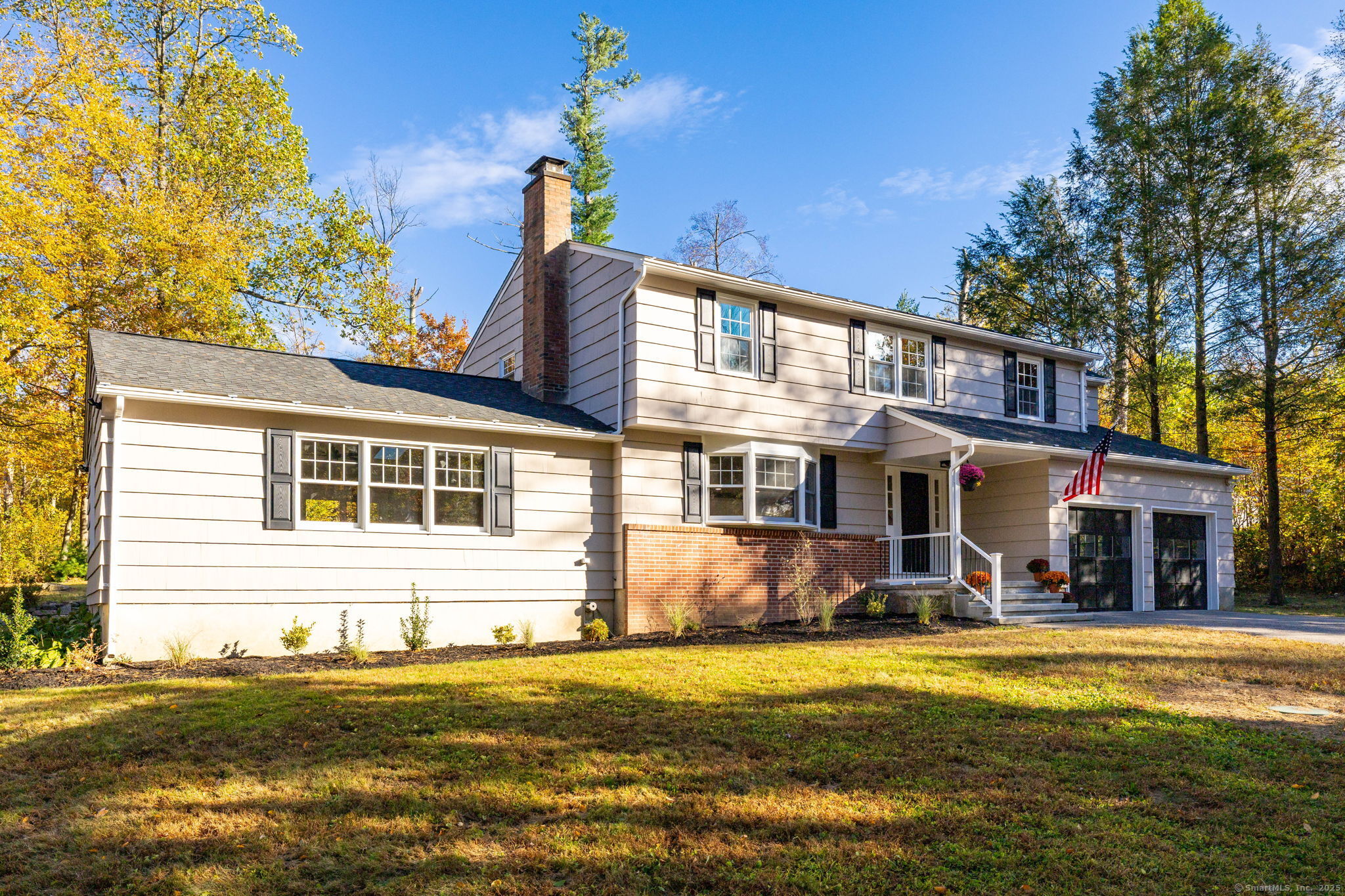 a front view of a house with swimming pool and porch