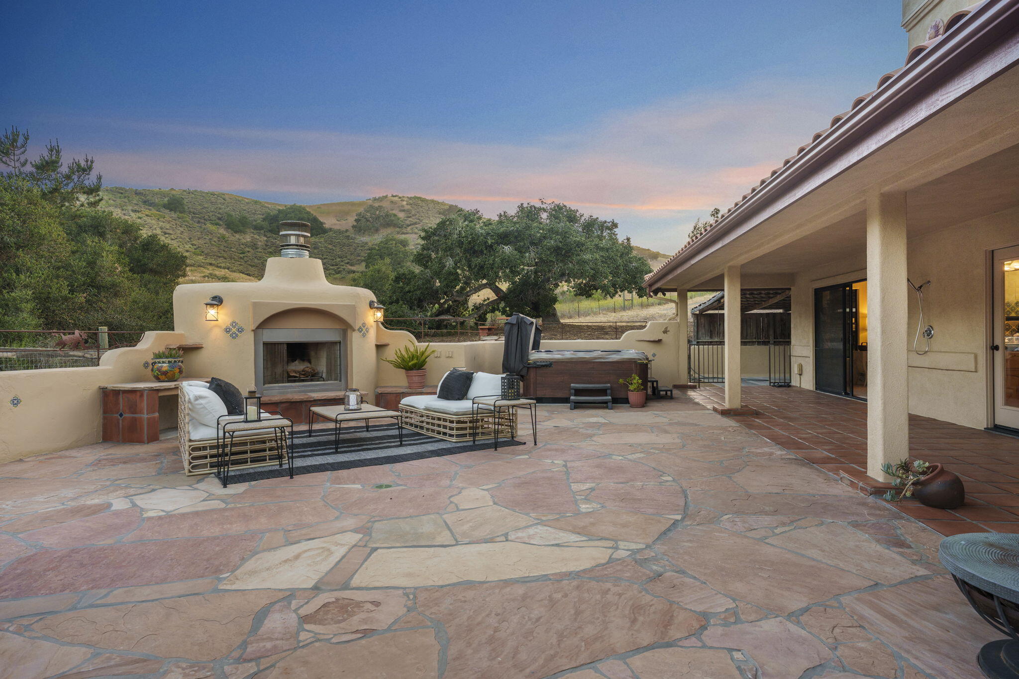 a roof deck with table and chairs a barbeque