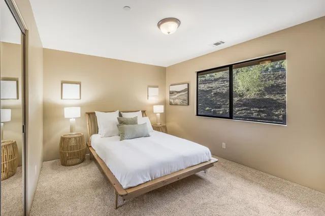 a backyard of a house with table and chairs