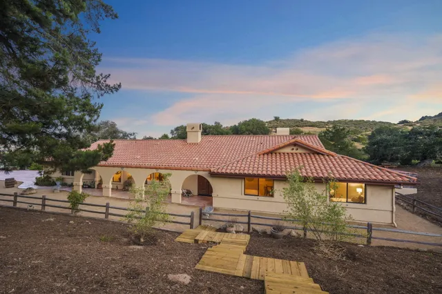 a view of a livingroom with wooden floor and a ceiling fan