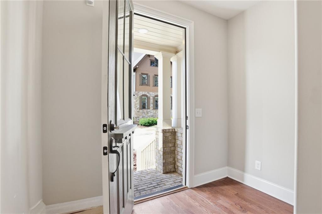 222 Trecastle Square, Unit 21 Canton, GA 30114 - Photo 3 of 33 a view of a hallway with wooden floor and door