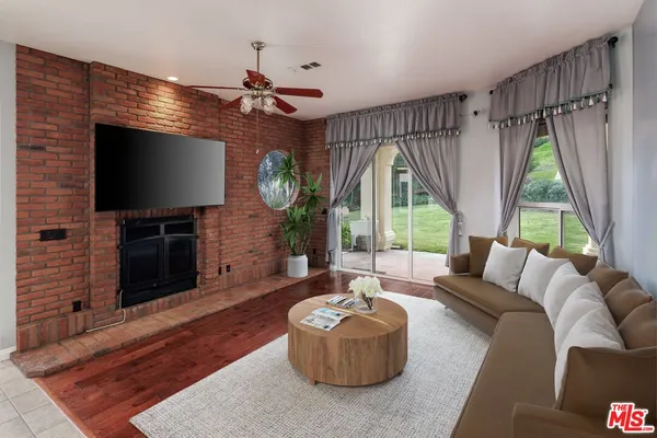 a living room with fireplace furniture and a flat screen tv