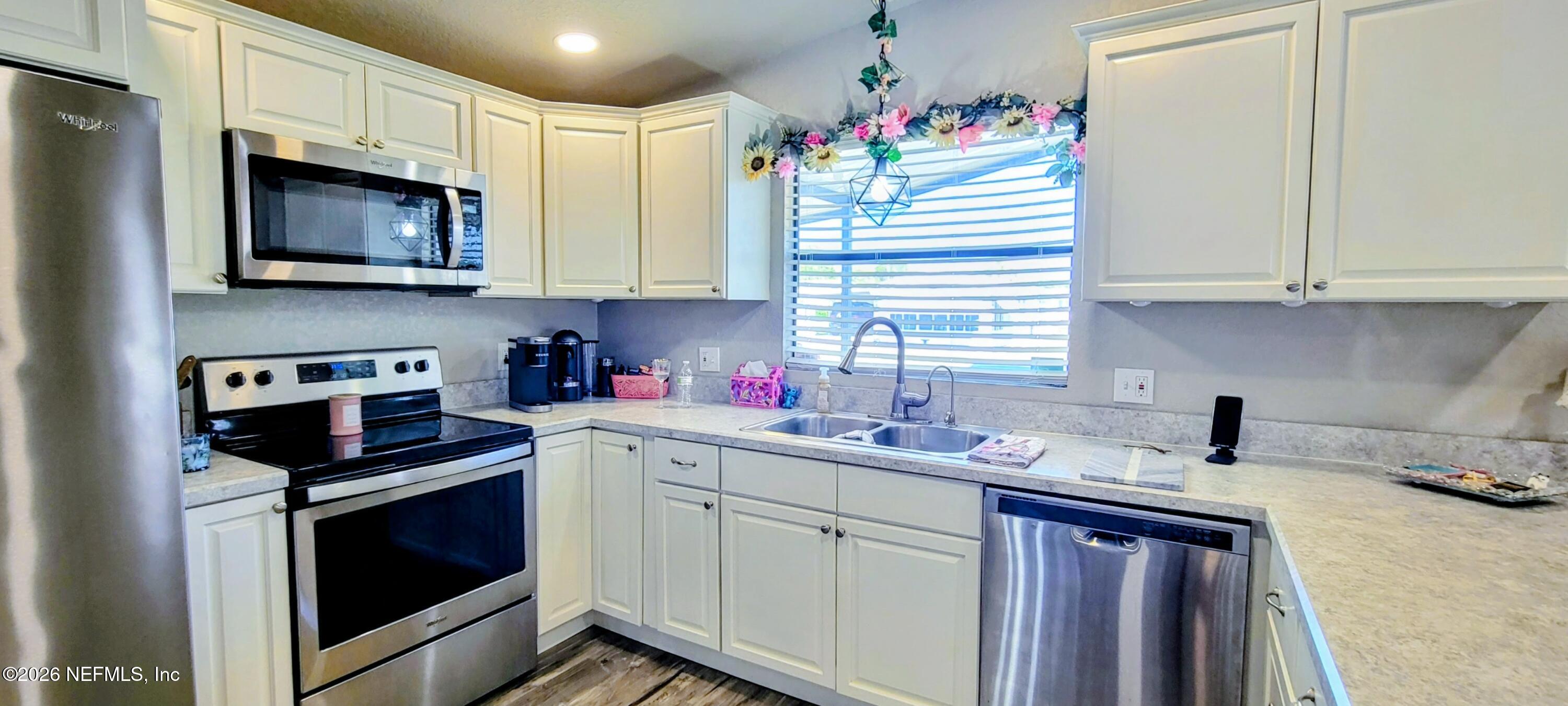 148 Rio Grande Edgewater, FL 32141 - Photo 11 of 74 a kitchen with granite countertop a sink stainless steel appliances and cabinets