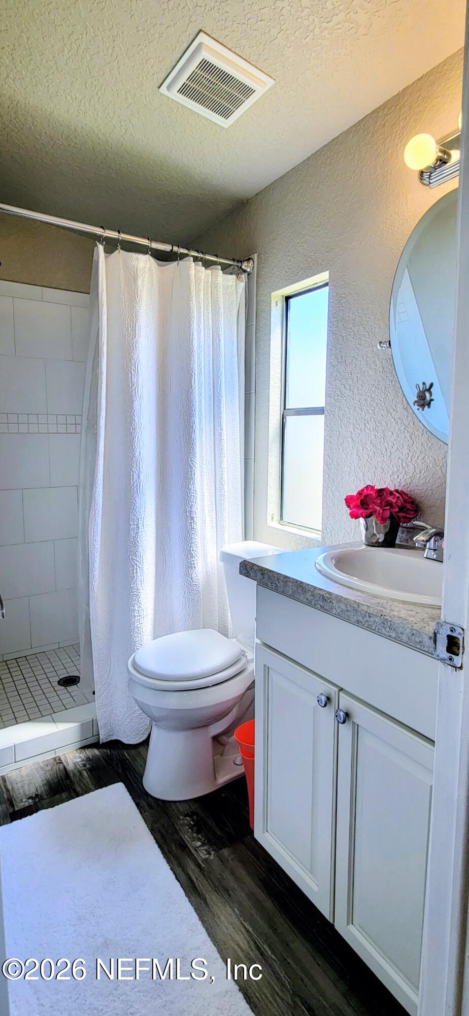 148 Rio Grande Edgewater, FL 32141 - Photo 36 of 74 a bathroom with a toilet sink and mirror