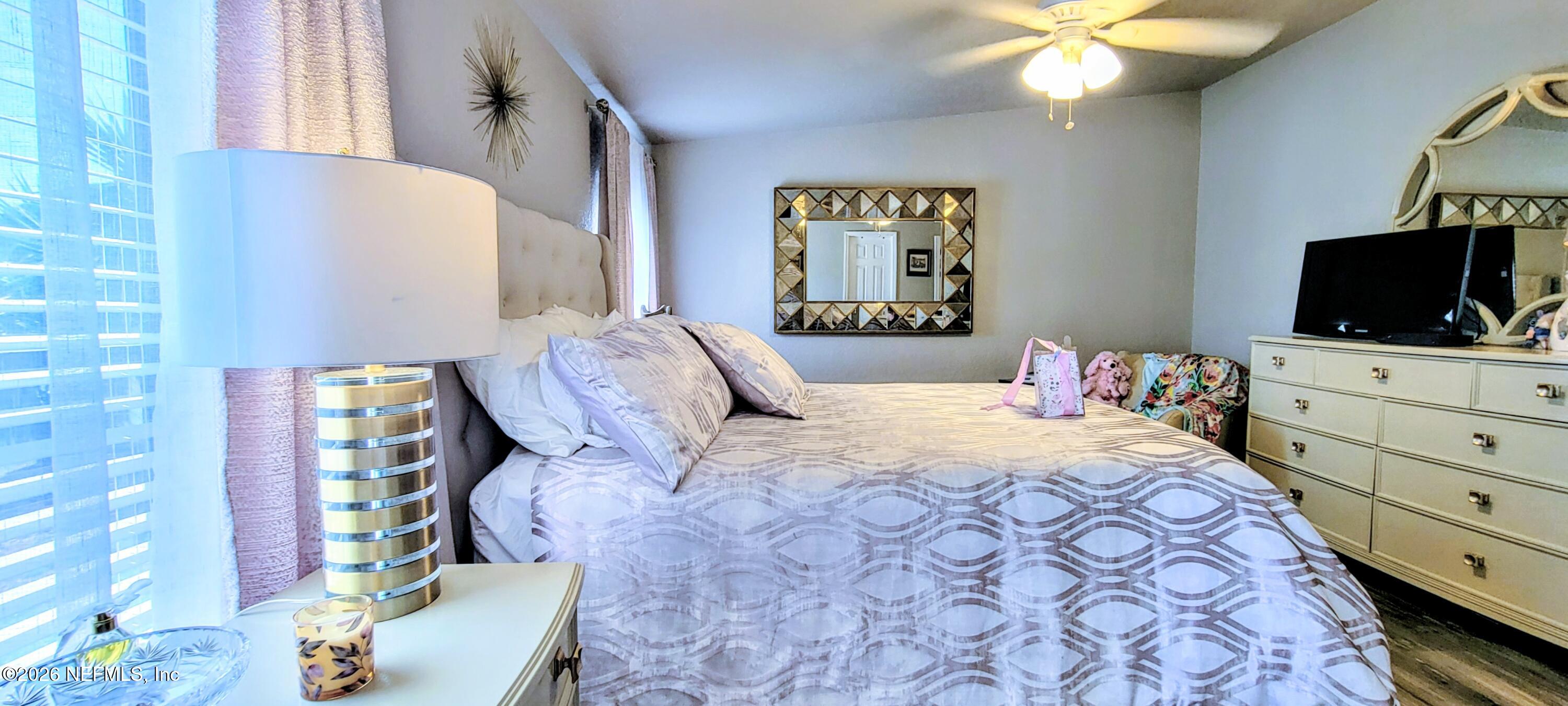 148 Rio Grande Edgewater, FL 32141 - Photo 38 of 74 a bedroom with a bed and a flat screen tv