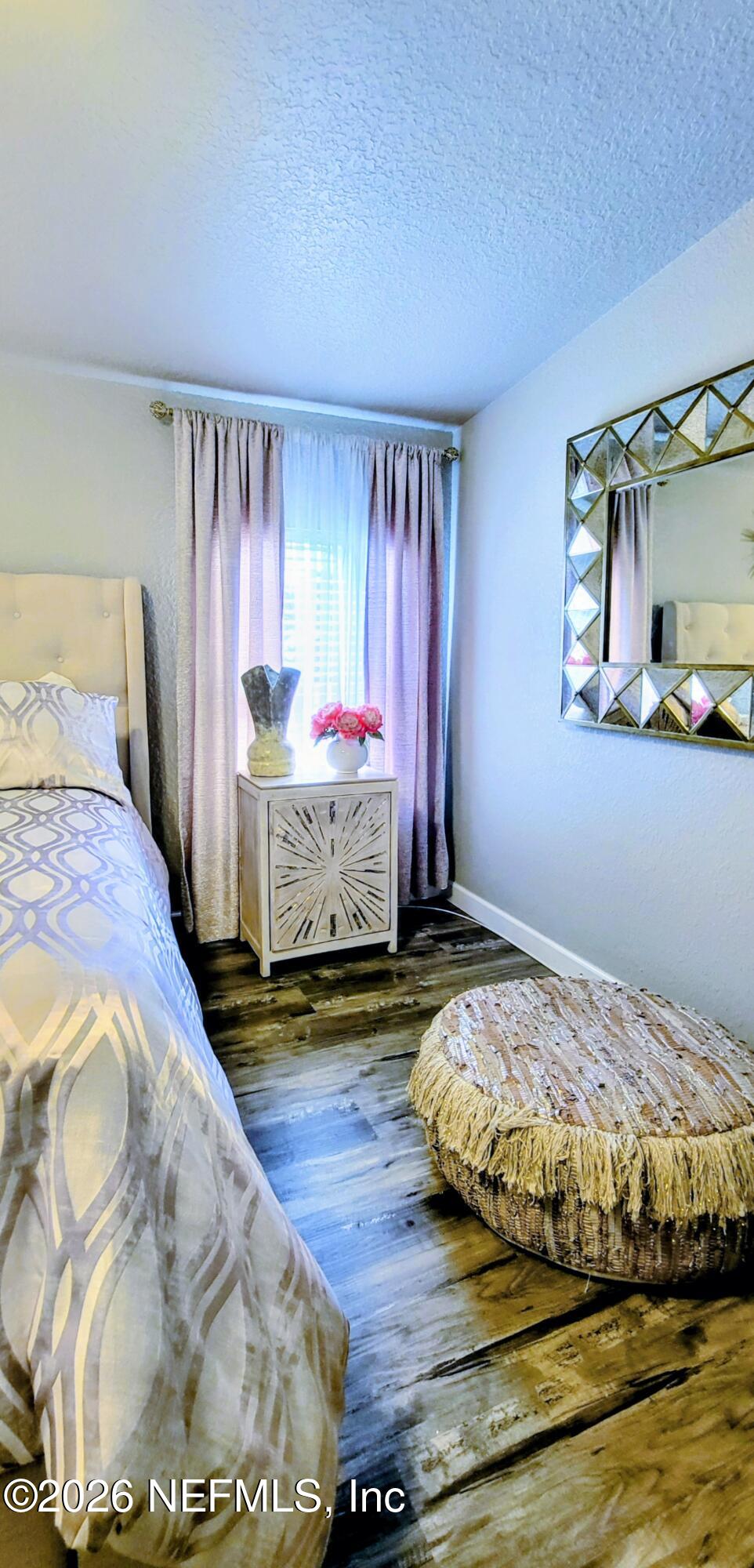 148 Rio Grande Edgewater, FL 32141 - Photo 39 of 74 a bedroom with a bed and wooden floor