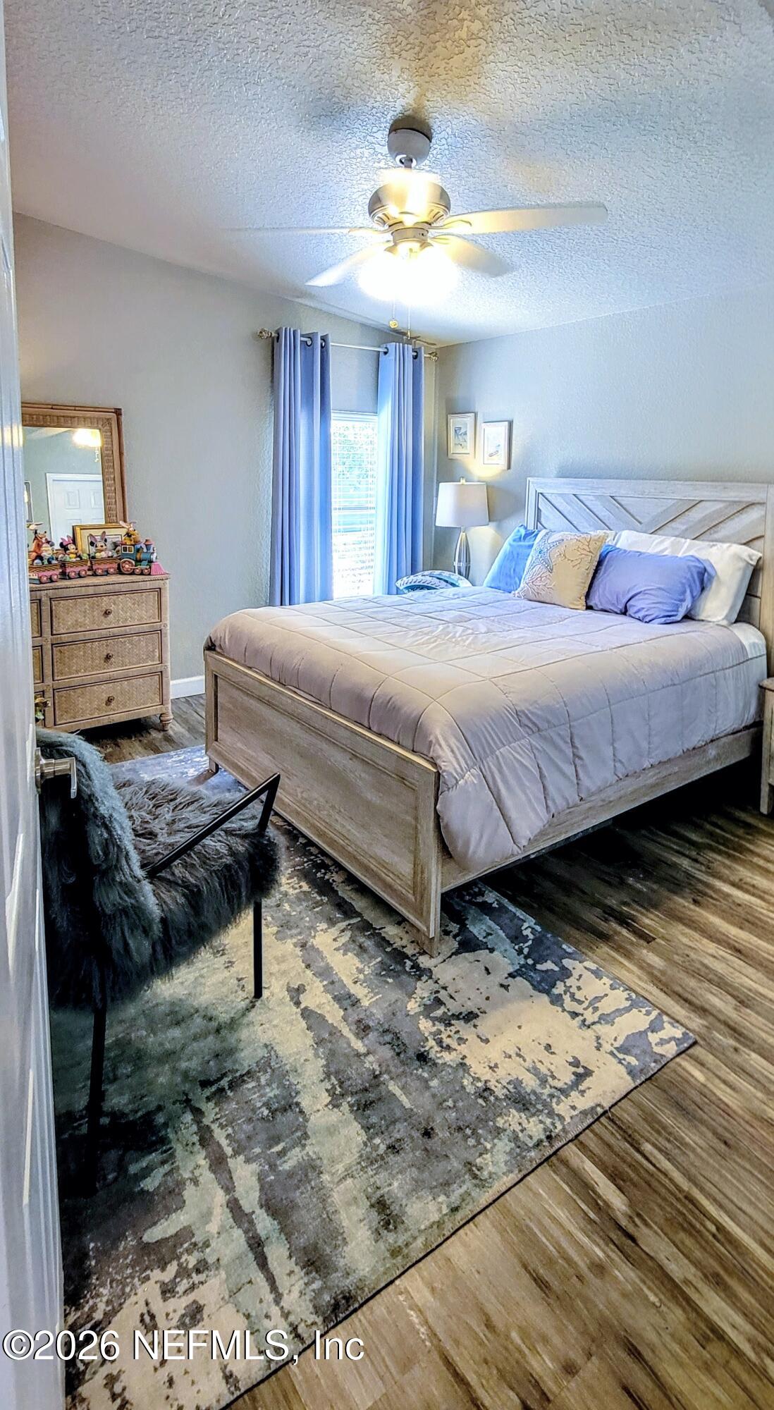 148 Rio Grande Edgewater, FL 32141 - Photo 41 of 74 a bedroom with a bed and wooden floor