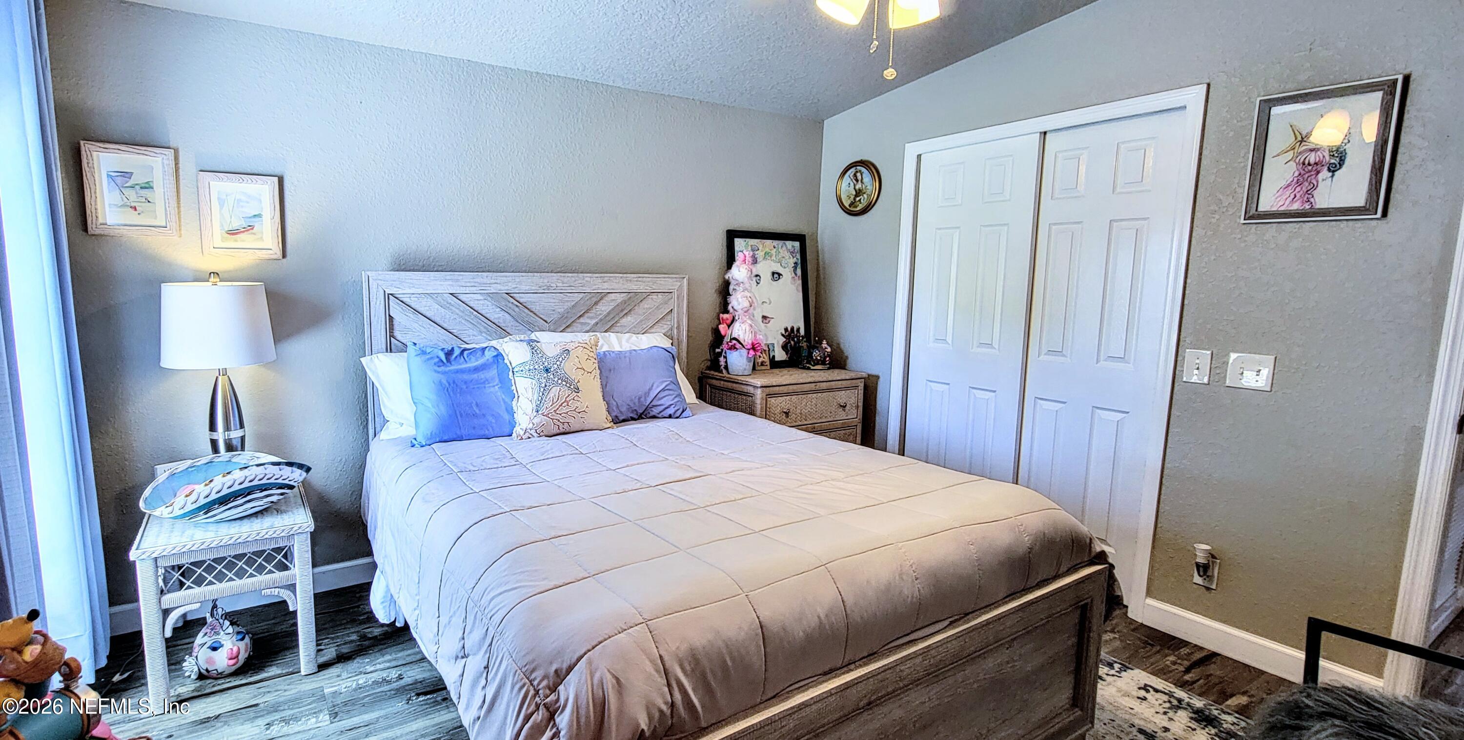 148 Rio Grande Edgewater, FL 32141 - Photo 43 of 74 a bedroom with a bed and wooden floor