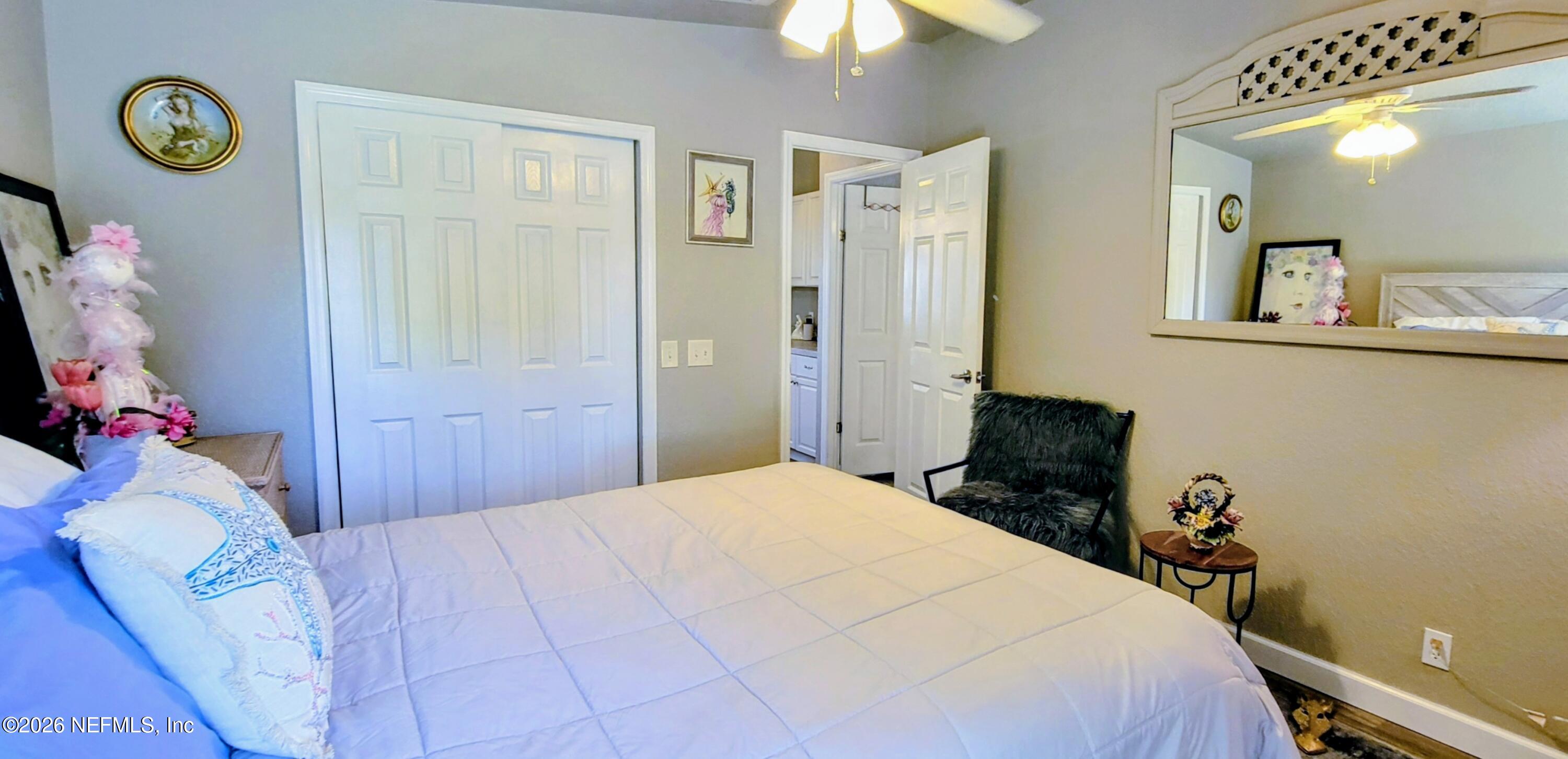 148 Rio Grande Edgewater, FL 32141 - Photo 45 of 74 a bedroom with a bed and a chandelier