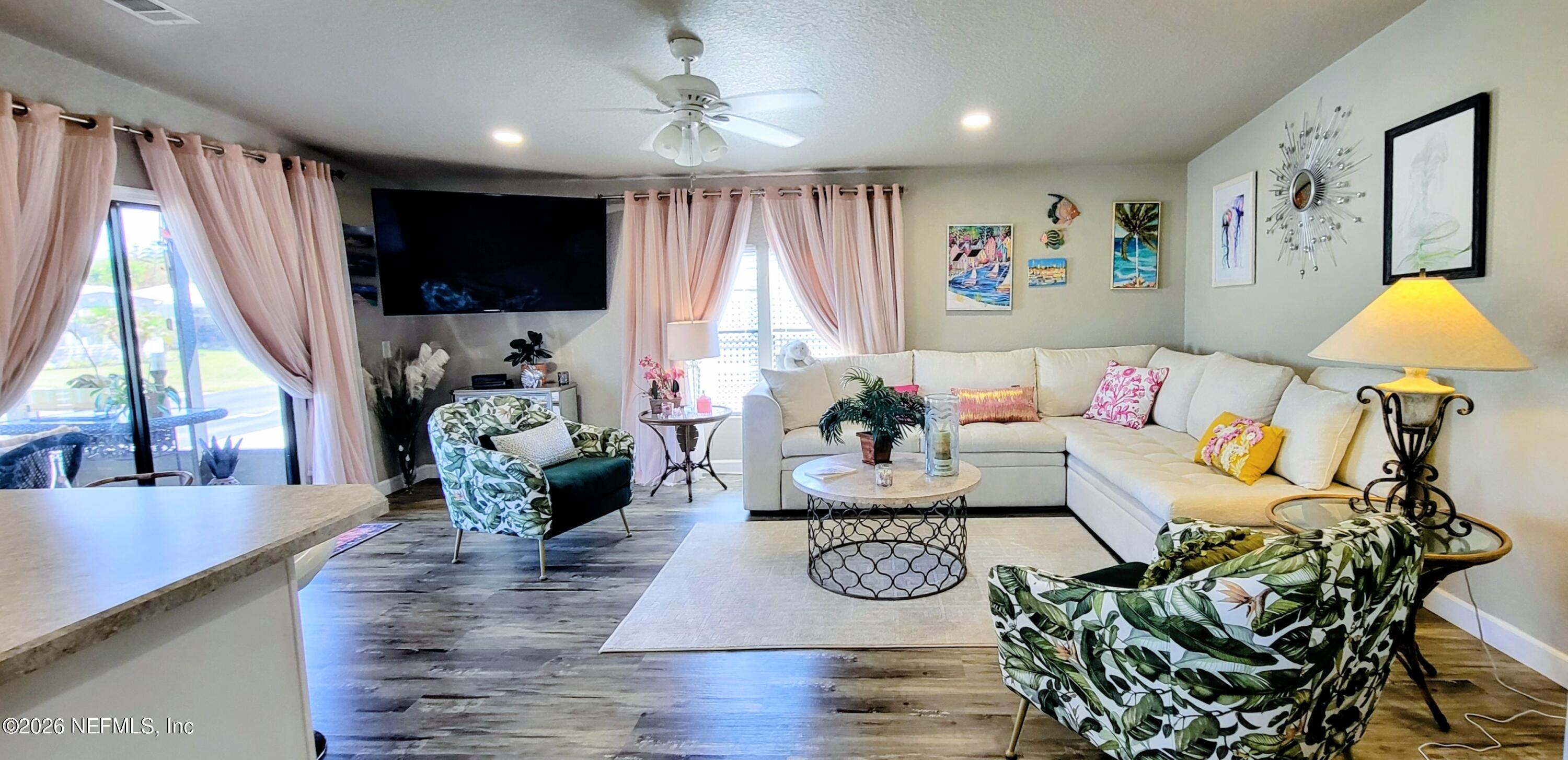 148 Rio Grande Edgewater, FL 32141 - Photo 49 of 74 a living room with furniture and a flat screen tv