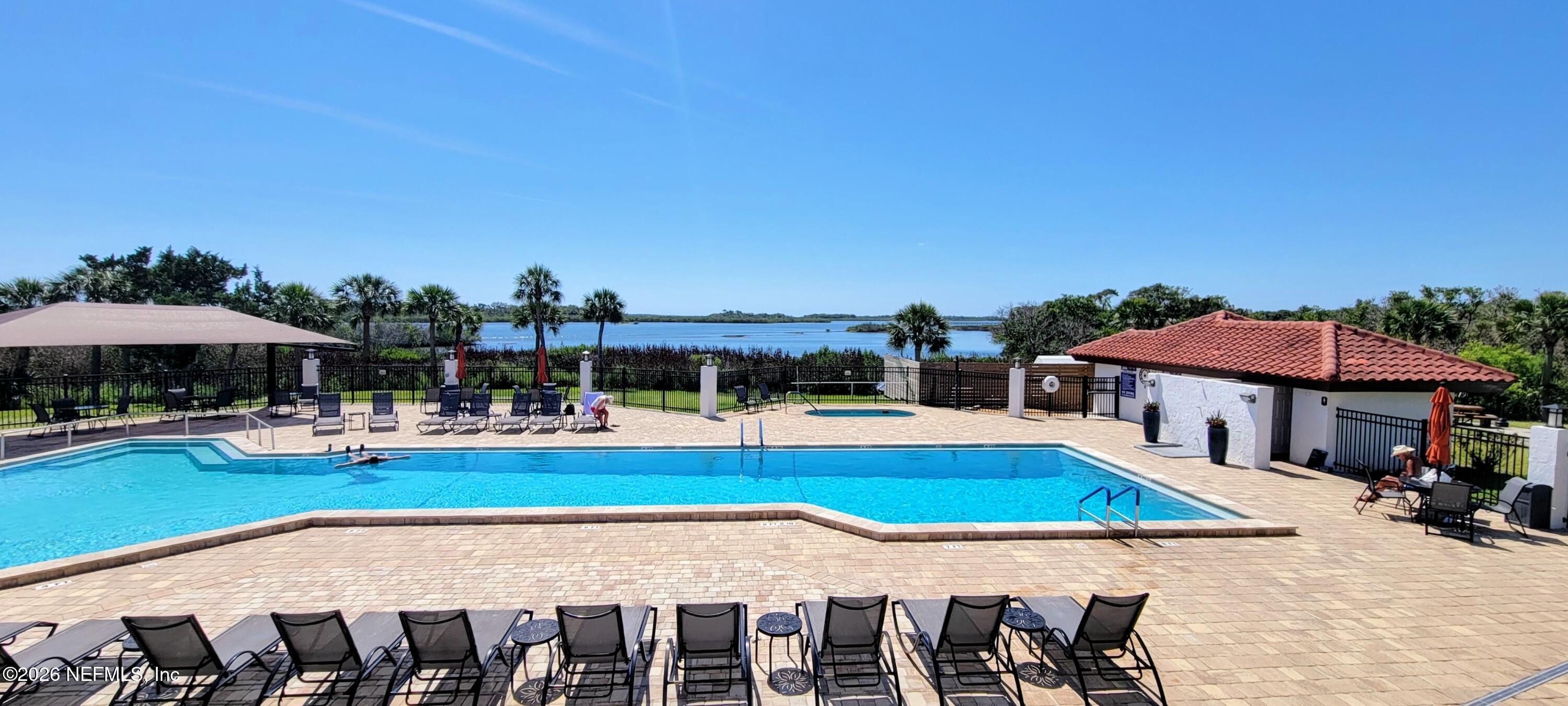148 Rio Grande Edgewater, FL 32141 - Photo 60 of 74 a view of a swimming pool with a table and chairs under an umbrella