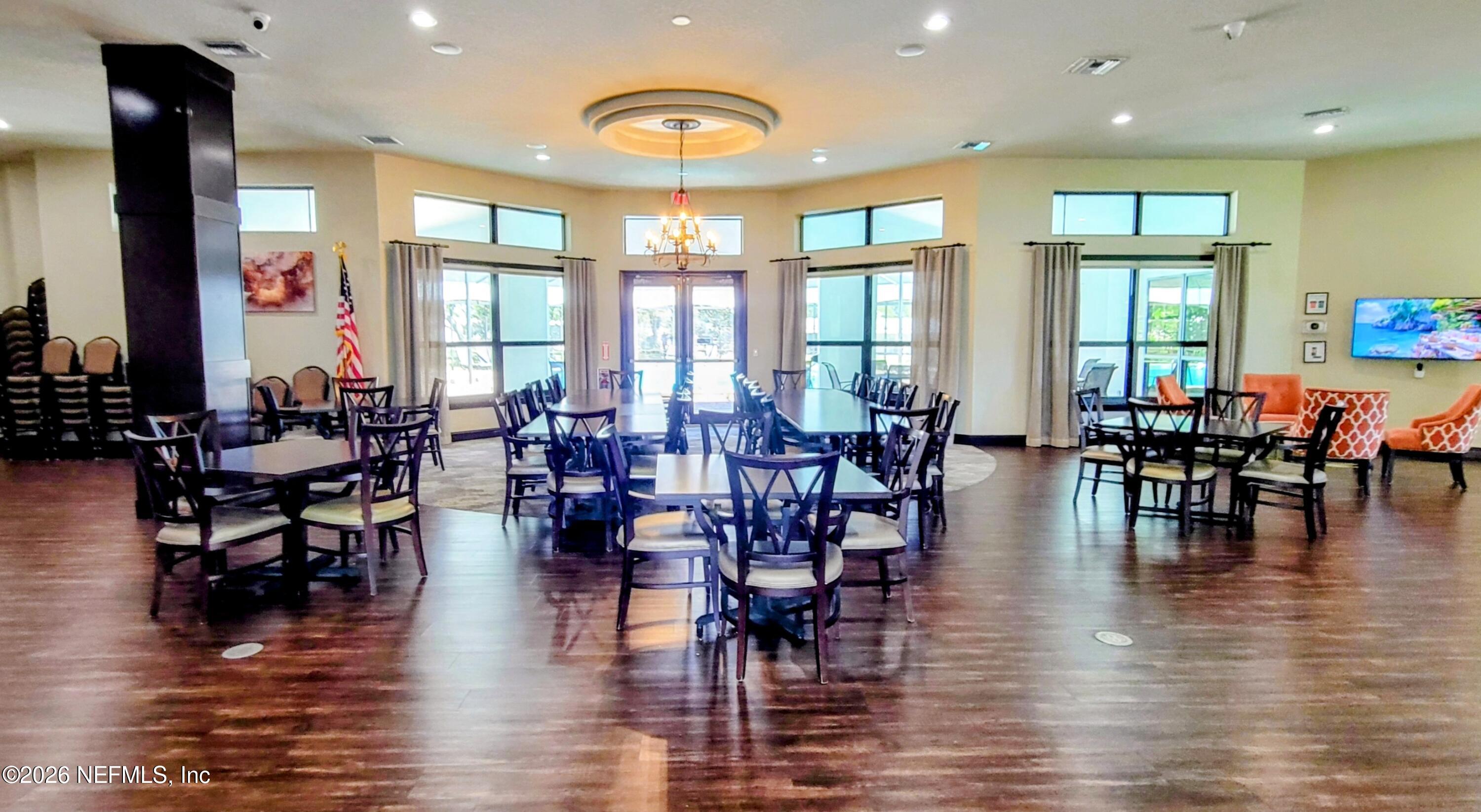 148 Rio Grande Edgewater, FL 32141 - Photo 73 of 74 a view of dining room and hall with furniture wooden floor and a large window