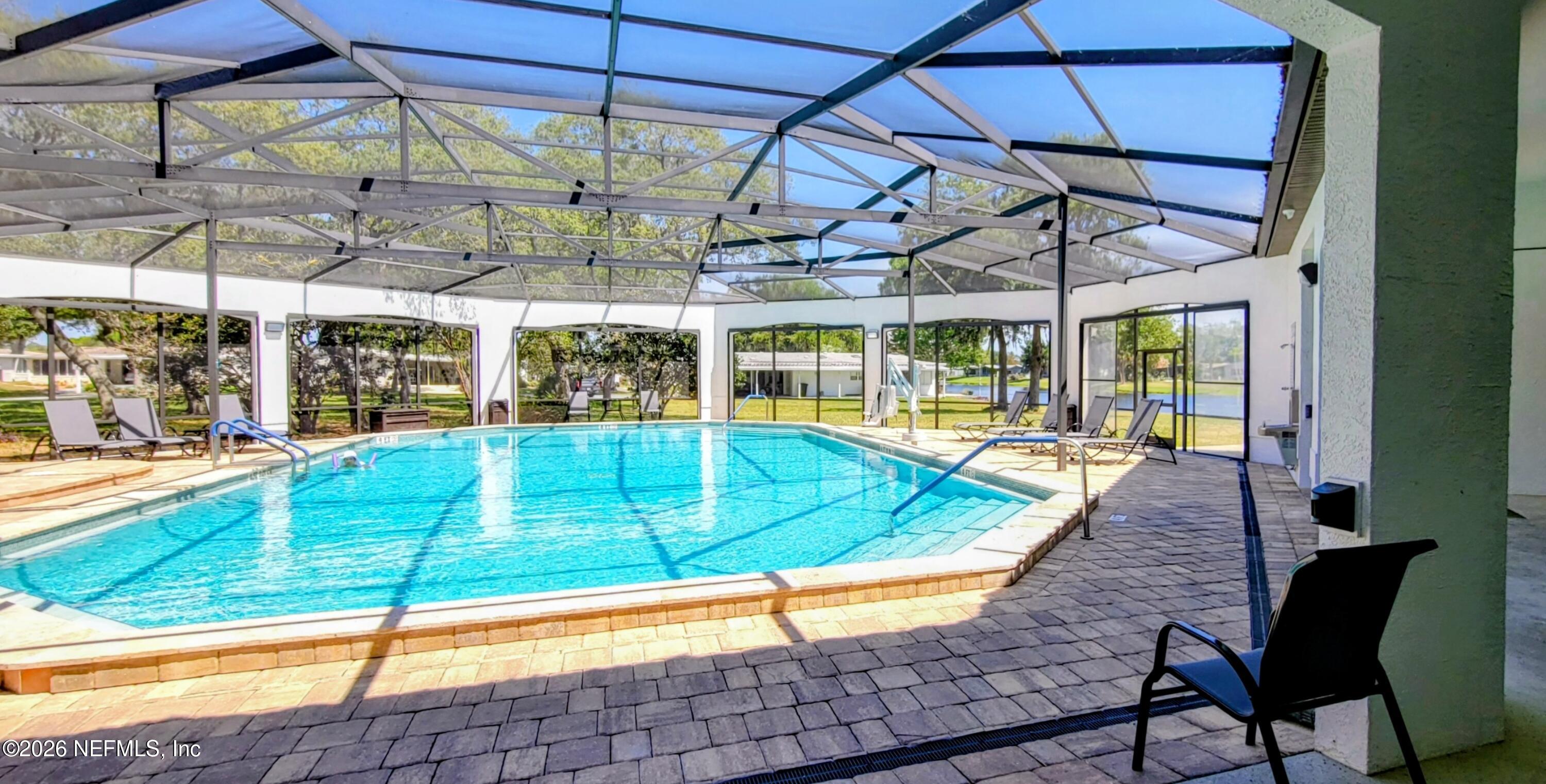 148 Rio Grande Edgewater, FL 32141 - Photo 74 of 74 a view of a swimming pool with a lounge chairs