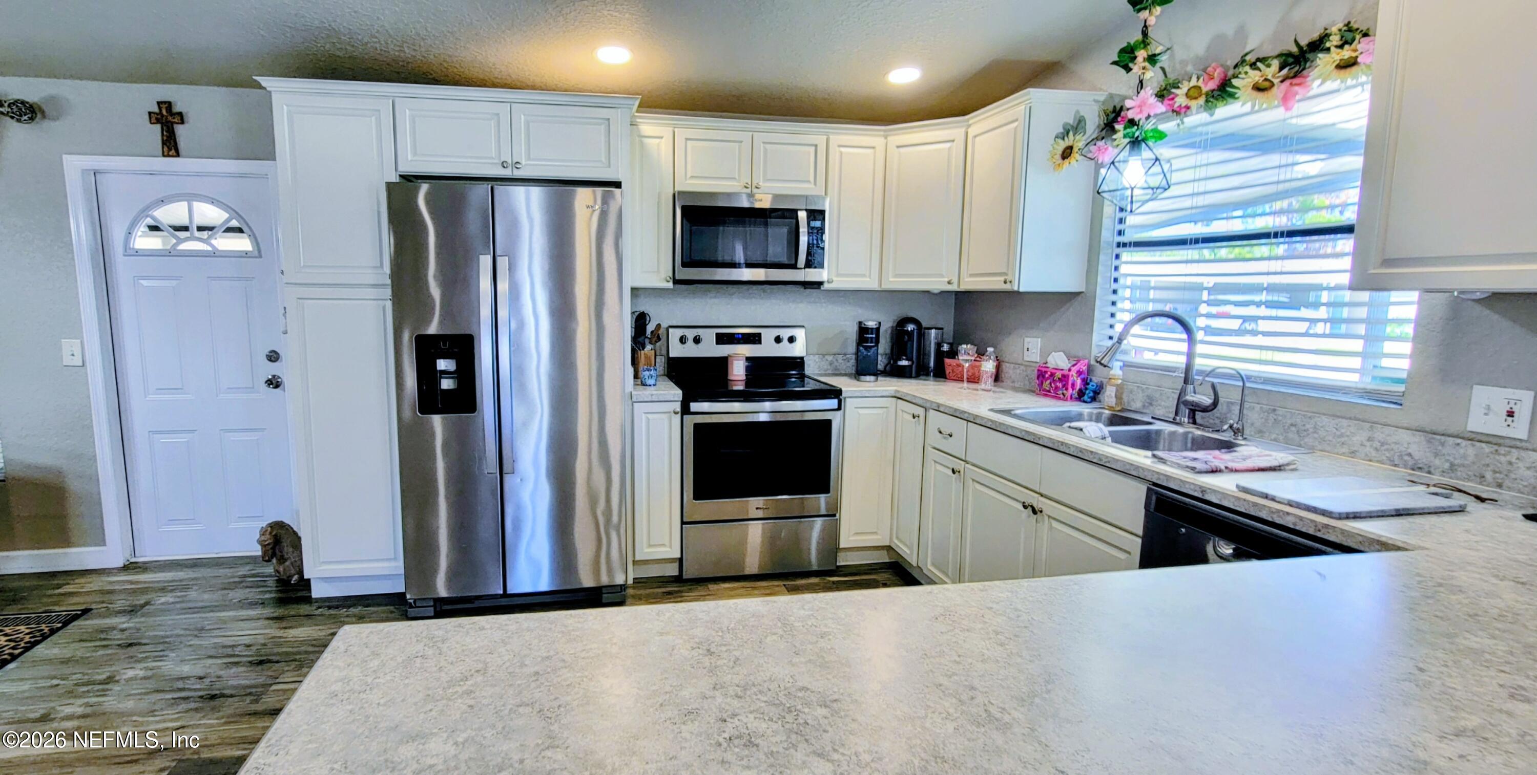 148 Rio Grande Edgewater, FL 32141 - Photo 10 of 74 a kitchen with granite countertop a refrigerator stove and sink