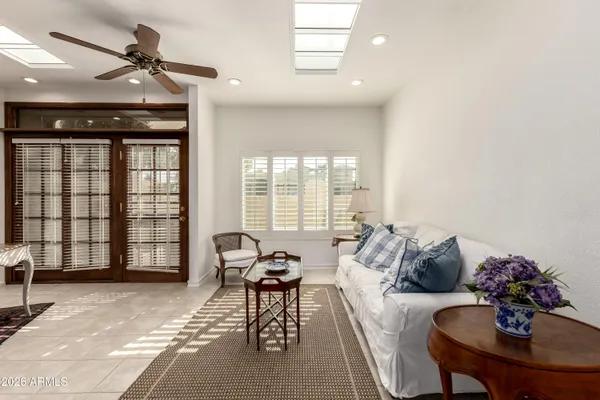 a spacious bedroom with a bed and a chandelier