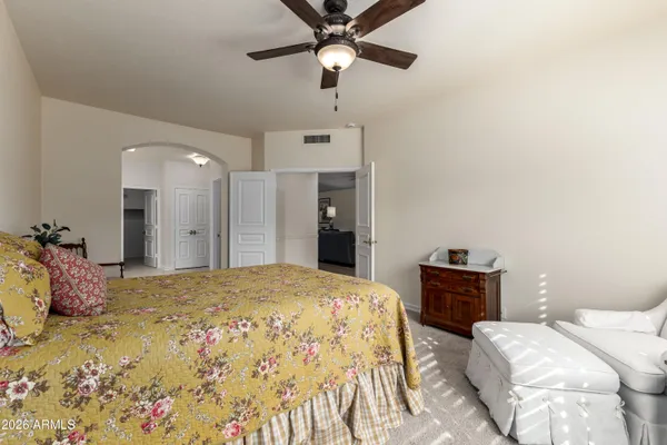 a spacious bathroom with a double vanity sink a large mirror and a shower