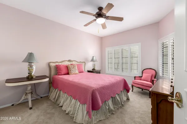 a bedroom with a bed and dresser with mirror