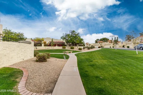 a view of a house with a big yard and potted plants