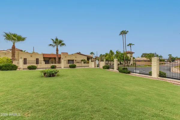 a row of palm trees and swimming pool in the backyard of house