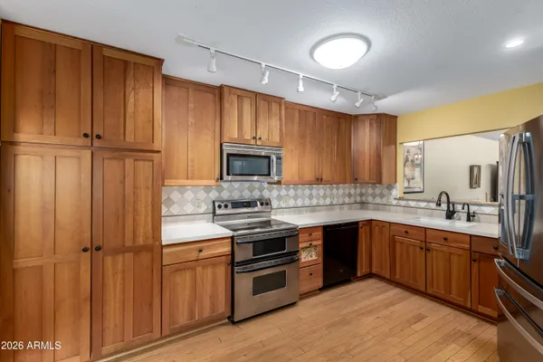 a kitchen with stainless steel appliances a stove and a refrigerator