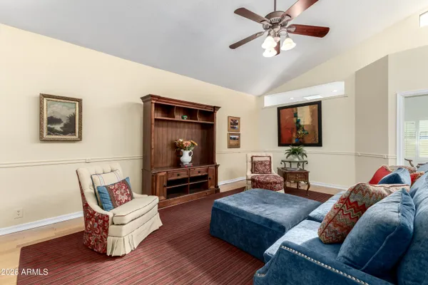 a living room with furniture and wooden floor