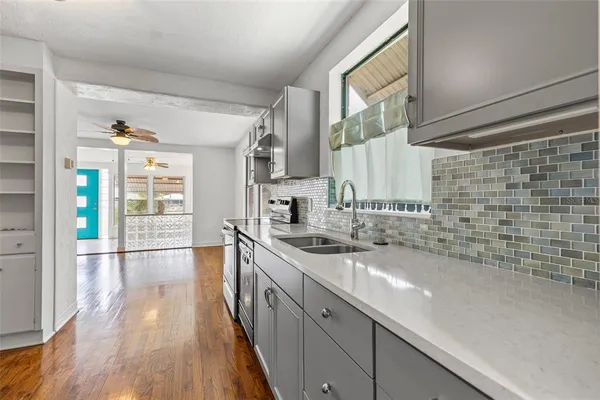 a kitchen with stainless steel appliances a refrigerator and a sink