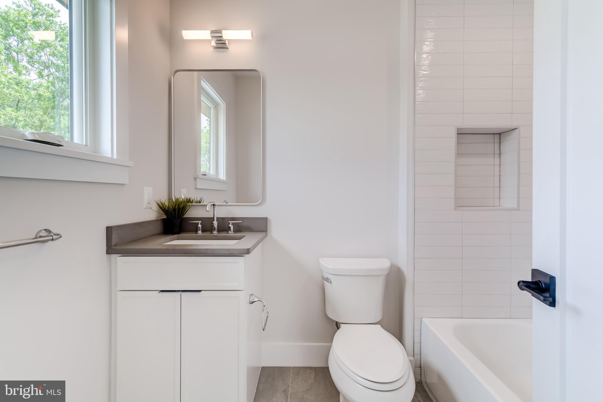 506 Kingsley Road Southwest Vienna, VA 22180 - Photo 109 of 150 a bathroom with a toilet a sink and a bathtub