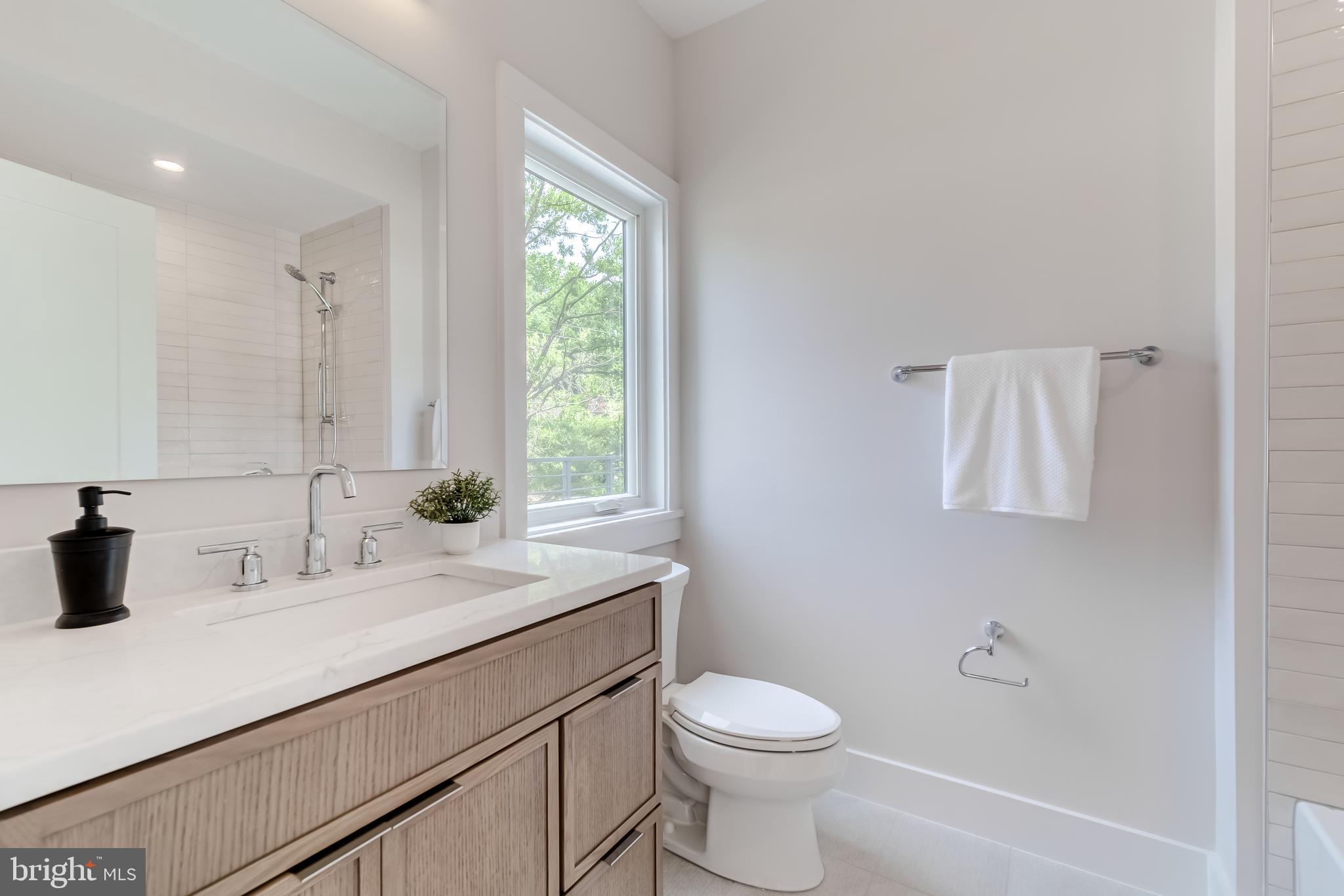 506 Kingsley Road Southwest Vienna, VA 22180 - Photo 95 of 150 a bathroom with a sink a toilet and a window