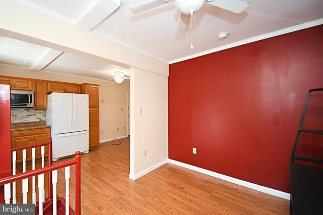 a kitchen with stainless steel appliances a sink a refrigerator and cabinets