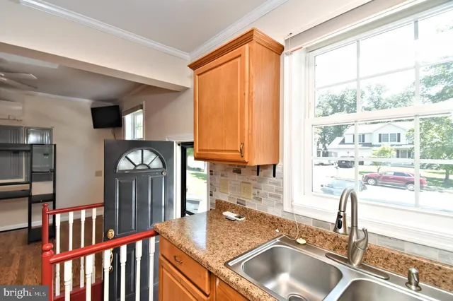 a kitchen with sink refrigerator and window